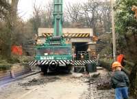 Weekend replacement of the narrow, low headroom, stone arch overbridge on Blacker Lane, Calder Grove, on the Wakefield - Barnsley line in 1991, with young son on standby if required.<br><br>[David Pesterfield 17/03/1991]