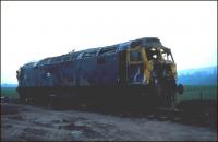 In fading light in a field near Forteviot in June 1982 stands badly damaged Class 47 no 47522. The locomotive had been working the 1335 Glasgow Queen Street - Aberdeen a month earlier on 4 May, when it ran into a tractor on a farm crossing nearby. The driver had seen the obstruction and was able to reduce speed but was still running at around 50mph at the point of impact. All except the last coach of the train left the rails and plunged 35 feet down an embankment. Some 62 people, including the train crew, sustained injuries, although, fortunately, there were no fatalities. 47522 was subsequently repaired at Crewe and continued in service until 1988. The 47 became something of a celebrity for a time, carrying a unique LNER-style apple green livery.<br>
<br><br>[Bruce McCartney 05/06/1982]