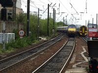 A ECR 225 comes off the Carstairs line from Glasgow Central with a service for King's Cross. The four car class 158 is headed for Kirkcaldy.<br><br>[Brian Forbes 11/05/2010]