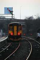 A single coach train heads towards Stoke from Uttoxeter. The west to north curve to Rocester was to the right and behind the camera and beyond the station an east to north curve completed a triangle of lines.<br><br>[Ewan Crawford 12/04/2010]