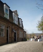 Its not only the platform area of Hebden Bridge that is attractive [See image 23133] but the external buildings too. This is the main booking office entrance and cobbled station forecourt. The station buffet is also doing a roaring trade on a fine April morning and customers are using the tables outside next to the bus turning circle. <br><br>[Mark Bartlett 24/04/2010]