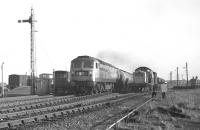 Class 47 no 1764 with the 13.00 Granton to Prestwick oil tanks passes Clayton no 8608 on ballast hoppers at Niddrie West Junction on 4 February 1970.<br><br>[Bill Jamieson 04/02/1970]