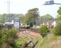 View north west at Annan on 13 May 2010 over the little used sidings at the rear of the down platform. In the background Freightliner 70003 brings a train of HHA high capacity coal hoppers past the signal box before running south through the station. <br><br>[John Furnevel 13/05/2010]