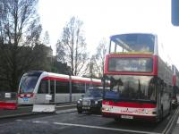 An eastbound Lothian no 12 bus passes the Edinburgh tram currently on static display on Princes Street on 14 May 2010.<br><br>[John Yellowlees 14/05/2010]