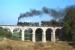 Scene on the Waldviertelbahn in Lower Austria in October 1985, close to the then Czechoslovakian border, as 760mm gauge 0-8+4 no 399.03 (of 'Stutztender' construction on the Engerth principle) crosses the viaduct at Weitra with train 71445, the 10.12 freight from Gmuend to Gross Gerungs. In the event the train did not reach its destination as the loco failed at Langschlag. By this date the line was nominally dieselised (except for weekend passenger workings during the summer which reverted to steam as a tourist attraction) but a shortage of diesels on this and other Austrian State Railways n.g. lines meant that one freight diagram was often still steam worked.<br><br>[Ingrid Jamieson 04/10/1985]