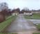 80 years to the day since its closure to passengers on 31st March 1930, this is the view west along the old GKER railway embankment east of Garstang towards the site of Garstang Town station. The station site itself has been built over. The railway bridge over the River Wyre was demolished after closure to goods in 1965 but a new bridge was installed as part of the water treatment and flood defence scheme seen here. My grandfather used to catch the <I>Pilling Pig</I> from Garstang Town to Garstang & Catterall to go to school in Lancaster but this was never a convenient journey for local residents and direct buses along the A6 later put paid to the train service. <br><br>[Mark Bartlett 31/03/2010]