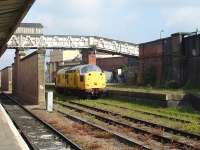 Network Rail ERTMS fitted locomotive no 97301 moves off overnight stabling in the loading dock siding opposite Platform 7 at Shrewsbury Station on 12 May 2010. The Dana footbridge crosses the station to give access to the riverside footpath, and Howard Street station car park. <br><br>[David Pesterfield 12/05/2010]