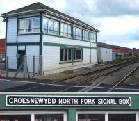 The signal box at Watery Road level crossing, located some 400m south of Wrexham General Station, and almost opposite the site of the former 89C Croes Newydd shed. The box also controls the run round siding on the up side from near the box to beyond the A525 Ruthin Road. View is south over the crossing towards Ruabon on 11 May 2010 with a close up of the signal box nameboard shown below.<br>
<br><br>[David Pesterfield 11/05/2010]