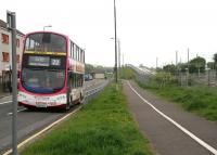 Pedestrians, buses, cyclists, trams and trains will all be catered for, as shown in this view west at Broomhouse on 23 May 2010. The Edinburgh tram route, built along the former guided busway, is climbing in the background to cross Broomhouse Road, with the catenary of the E&G visible on the far right of the picture. [See image 29063] <br><br>[John Furnevel 23/05/2010]