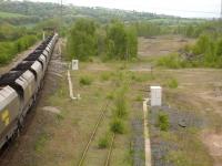 A Freightliner class 66 with a loaded coal train held at signals at Healey Mills on 14 May 2010. The train is waiting to proceed west along the perimeter of the area once occupied by the east end reception sidings.<br><br>[David Pesterfield 14/05/2010]