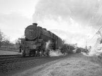 Black 5 4-6-0 no 44731 with a southbound freight on the WCML, thought to have been photographed just south of Wreay around 1965. The freight is conveying a small number of 6-wheel milk tanks immediately behind the locomotive, the residue of what had once been a separate milk train running between Carlisle and Willesden until at least the middle of 1964.<br>
<br><br>[Robin Barbour Collection (Courtesy Bruce McCartney) //1965]