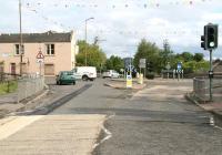 The site of Glasgow Road level crossing in Bathgate in May 2010,  some 40 years on from the recent mystery photograph [see image 29153]. The site is now a roundabout, seen here from Menzies Road, with the building on the left providing the link with the 1970 image. While chimneys, windows and doors have all been subject to modification the distinctive roof line remains. The sign on the building today is that of a West Lothian Council adult learning centre.      <br>
<br><br>[John Furnevel 30/05/2010]