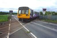 A Northern rail Newcastle to Carlisle service crosses the B6321 just west of Corbridge on 30 May 2010. <br><br>[John Steven 30/05/2010]