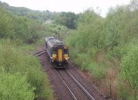 The first train of the day for Glasgow leaves Fort William. 156456, which started its journey at Mallaig, is passing the junction with the line into the aluminium smelter [See image 26275] still controlled by the semaphore signal and bracketed shunting disc. <br><br>[Mark Bartlett 19/05/2010]