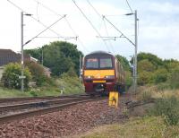 320317 crosses Bainfield level crossing on the approach to Cardross on 29 May with a service for Helensburgh Central.<br><br>[John McIntyre 29/05/2010]