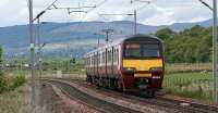 A Helensburgh - Airdrie service approaching Brooks Farm LC on 28 May 2010 in the hands of 320316.<br>
<br><br>[John McIntyre 28/05/2010]