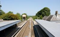 View north from Kemble station towards Gloucester on 3 June 2010. Note the former GWR water tank still standing just beyond the down platform.<br><br>[Peter Todd 03/06/2010]