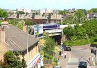 A Glasgow Central - Edinburgh Waverley service slowly crosses the bridge over Slateford Road on the west side of Edinburgh on 2 June 2010 as it pulls into the eastbound platform of Slateford station.<br><br>[John Furnevel 02/06/2010]