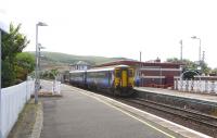 Having arrived at Girvan from Kilmarnock, 156 552 waits to return there with the 1206 departure on 3 June. Note the period ironwork around the subway entrances of what is Scotland's only art deco station.<br><br>[David Panton 03/06/2010]