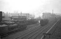 With the platforms of Dalry Road station in the background, Kingmoor's Britannia Pacific no 70023 <I>Venus</I> moves off Dalry Road shed and reverses towards Princes Street to take over a train on 24th March 1962. Also in evidence on shed are a Caley 3F, a Standard Class 2 and a Black 5. Nowadays this view is completely dominated by the Western Approach Road - although the (Edinburgh-bound) platform edge at Dalry Road station has miraculously survived. [See image 29250]<br><br>[Frank Spaven Collection (Courtesy David Spaven) 24/03/1962]