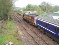 The Caledonian Sleeper (Fort William portion) and 67007 at Spean bridge, the penultimate stop on the long journey from Euston. This view looks towards Fort William and also shows the disused remains of the Fort Augustus branch curving away to the right in front of the loco.<br><br>[Mark Bartlett 19/05/2010]