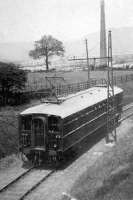 One of the Dick Kerr overhead electric rail coaches that operated experimentally on the Holcombe Brook branch for five years before the line was converted to third rail operation in 1918. This interesting photo, taken between Tottington station and viaduct, also shows the OLE masts, several bases of which still survive alongside the old track bed. [See image 21770]. Photo courtesy of Bury Historical Society.<br><br>[W A Camwell Collection (Courtesy Mark Bartlett) //1913]