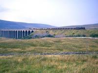 An 8F crossing Ribblehead Viaduct with a southbound freight in the sixties.<br><br>[Robin Barbour Collection (Courtesy Bruce McCartney) //]