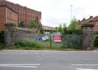 A branch off the Bristol - Portishead line at Ashton Junction ran towards the western end of Bristol docks. On reaching Ashton Swing Bridge Junction the line then split to serve Canons Marsh Goods Depot to the north, with the southern link running to the location of the current Bristol Industrial Museum HQ. The junction was adjacent to the road bridge shown in the background beyond the former level crossing and gate pillars.<br><br>[Peter Todd 10/06/2010]