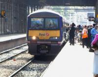 The roof glazing at Waverley may be about to be cleaned or replaced, <br>
but that doesn't mean the station is particularly gloomy at the moment.322 481 for North Berwick picks up plenty of custom at a sun-drenched platform 11 on 4 June. This is one of the two daily services which have come from Glasgow Central via Carstairs. These workings, back and forth, allow transfer to and from Shields depot and will presumably cease when Airdie to Bathgate opens in December. <br>
<br><br>[David Panton 04/06/2010]