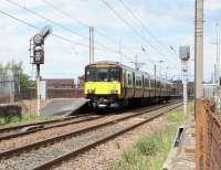 318 265 pulls out of Ardrossan South Beach with an Ardrossan Harbour to Glasgow Central service on 14 June 2010.  The platform line is bi-directional, but the line in the foreground is Up Freight only.  As with all single-platform stations the digitised announcements refer to the platform as 'platform 1'; perhaps they think 'the platform' sounds a bit pathetic.'<br><br>[David Panton 14/06/2010]