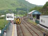 Looking east from Machynlleth footbridge with the former steam shed in the right background, signal box on the left and new ERTMS signalling centre on the right. 158839 heads onto the depot after arriving on the 15.34 ex Pwllheli. [See image 38830] <br><br>[David Pesterfield 09/06/2010]