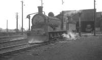 J36 no 65319, complete with snowplough, takes on water outside Bathgate shed on 5 March 1966.<br><br>[K A Gray 05/03/1966]