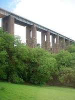 The magnificent Liskeard viaduct, carrying the Cornish main line, as seen from the Looe branch train that has just passed under this structure while climbing from Coombe Junction up to Liskeard. For a superb picture that exemplifies the steep gradient on this link line [see image 17767].<br><br>[Mark Bartlett 15/06/2010]