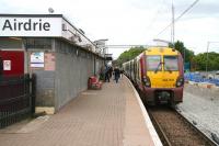 Passengers leave a train from Helensburgh Central recently arrived at Airdrie platform 2 on 14 June. With Airdrie currently the eastern terminus of the line once again [see image 29418] passengers for Drumgelloch need to transfer to a bus service operating from the station car park.<br><br>[John Furnevel 14/06/2010]