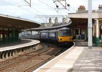 Northern rail 144015 arrives at Carnforth station with a Leeds to Heysham Port service on 19 June 2010.<br>
<br><br>[John McIntyre 19/06/2010]