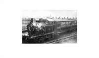 A L&YR railmotor stands in Holcombe Brook station with the engine facing the buffers and railway staff posing for the camera. An undated photo that may have been taken around 1905, when the railmotors were introduced to compete with a new tram service and additional halts opened on the branch. It was certainly taken before 1913 when the branch was electrified. [See image 22369] for a view of the same spot some 47 years later with another L&YR loco on the last weekend of service. Photo courtesy of Bury Historical Society.<br><br>[W A Camwell Collection (Courtesy Mark Bartlett) //1905]