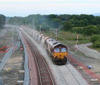 66065 heads west with ballast on the evening of 22 June 2010<br><br>[James Young 22/06/2010]