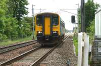 Looking south along the WCML at Bolton-Le-Sands towards Hest Bank on 19 June 2010 as 153363 approaches the level crossing with a service to Carlisle via Barrow and the Cumbrian Coast.<br><br>[John McIntyre 19/06/2010]