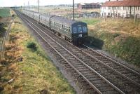 An eight car DMU heading for Edinburgh Waverley on the run down from the Forth Bridge passes 1959 urban expansion taking place at Broomhall on the approach to Saughton Junction.<br><br>[A Snapper (Courtesy Bruce McCartney) 25/07/1959]