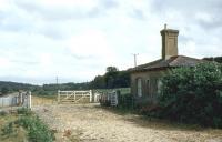 The trackbed of 'Castleman's Corkscrew' looking south east as it crosses Holmsley Passage (a minor road in the New Forest) in July 1971. The crossing keepers house is still intact as are the level crossing gates. <br>
<br><br>[John McIntyre /07/1971]