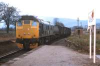 A local freight from Inverness propels wagons back into Alness sidings in May 1973. Just behind the loco is a demountable tank container, almost certainly destined for the private siding at Invergordon grain distillery. [See image 29585]<br>
<br><br>[David Spaven /05/1973]