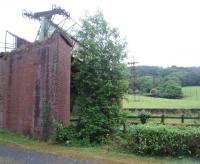 As seen here, the buckets on the aerial ropeway at Claughton brickworks were removed when the brickworks was mothballed by Hansons during the economic downturn but happily it returned to use in 2013. This is the last gravity operated ropeway in the United Kingdom and can carry 250 tons of material a day down 750' from Caton Moor over a distance of just over a mile. It was constructed in 1924 and its historic status has been recognised by the Transport Trust [see image 29588].<br><br>[Mark Bartlett 29/06/2010]