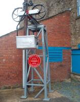 A Transport Trust red plaque, along with a model gantry and bucket, stands outside the lower wheelhouse of the Claughton aerial ropeway, alongside the A683 main road through the village. This is in recognition of it being the last working gravity operated ropeway in the UK. <br><br>[Mark Bartlett 29/06/2010]