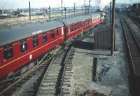 The empty stock of <i>The Talisman</i> at Craigentinny carriage sidings on 30 September 1959. The set is in the process of leaving the sidings for Waverley banked by a V3 locomotive. [Note: Coach E1723E nearest the camera was half of one of the twin-articulated Open Firsts built for the LNER 'Coronation' streamliner service in 1937.</I>]<br><br>[A Snapper (Courtesy Bruce McCartney) 30/09/1959]