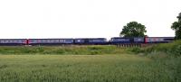 A pair of First Great Western HSTs 'kissing' at speed on the GWR main line near the village of Fernham, to the east of Swindon. Photographed on 28 June 2010.<br><br>[Peter Todd 28/06/2010]