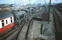 The empty stock of <I>The Talisman</I> being assisted out of Craigentinny sidings by V3 no 67670 on 30 September 1959. Classmate 67672 is standing on the adjacent line. Given BR's normal practice of marshalling a complete maroon set for <I>The Talisman</I> [see image 29600] the presence of <I>Blood & Custard</I> BR MkI BSO E9284 suggests it may have been substituted for a failure.<br><br>[A Snapper (Courtesy Bruce McCartney) 30/09/1959]