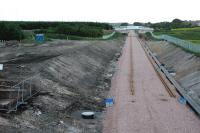 View west over Westcraigs Junction. It's much more difficult now to tell this is a former junction site with the former line to Shotts taking off to the left. Rails have been placed on the prepared trackbed and at the time of the photograph overhead masts only extend from Bathgate to the west end of the former Westcraigs station.<br><br>[Ewan Crawford 27/06/2010]