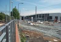 The new Metrolink Trafford tram depot, as seen here looking north from the down platform at Old Trafford station prior to opening. This huge facility sits in the 'V' of the Altrincham and East Didsbury lines stretching almost to the next station at Trafford Bar. It houses part of the new fleet of 3000 series trams being introduced for the Metrolink extensions to Rochdale and Disdbury. <br><br>[Mark Bartlett 30/06/2010]