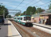 The new junction for the Didsbury line can be seen immediately behind this Altrincham to Bury tram arriving at Trafford Bar. To maintain capacity however a <I>diveunder</I> has been created for Manchester bound trams rather than a plain junction. Being able to use the old MSJA OLE gantries must have saved a fortune when this line was converted to Metrolink in 1992.<br><br>[Mark Bartlett 30/06/2010]