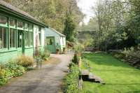 Platform view at Langley on the Allendale branch, looking towards Hexham in May 2006. The former station, hidden away in the South Tyne valley, is now a garden, crafts and walking centre. The tea-room at the end of the platform is known as <I>'The Leaning Shed Cafe'</I> for some reason.<br><br>[John Furnevel 10/05/2006]